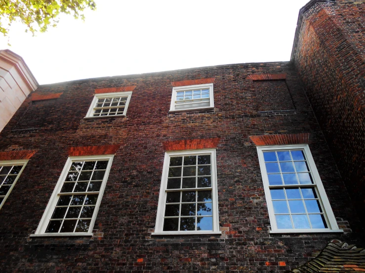 a building with three windows and a clock on the corner