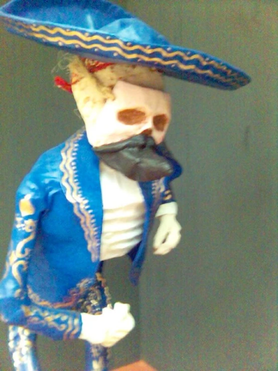 a white skull wearing a blue hat standing on a red platform