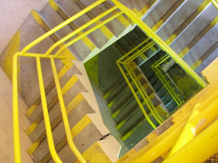 some yellow painted steps with some stairs leading up