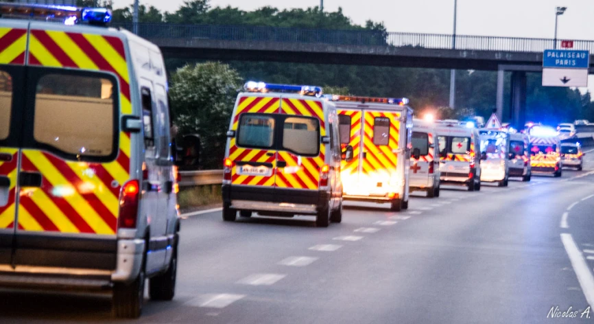 ambulances are lined up near one another on the road