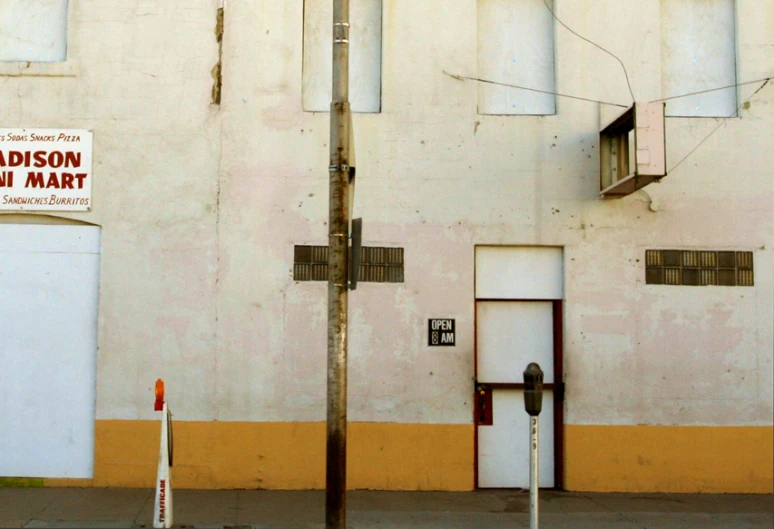 a small building with a street light by it