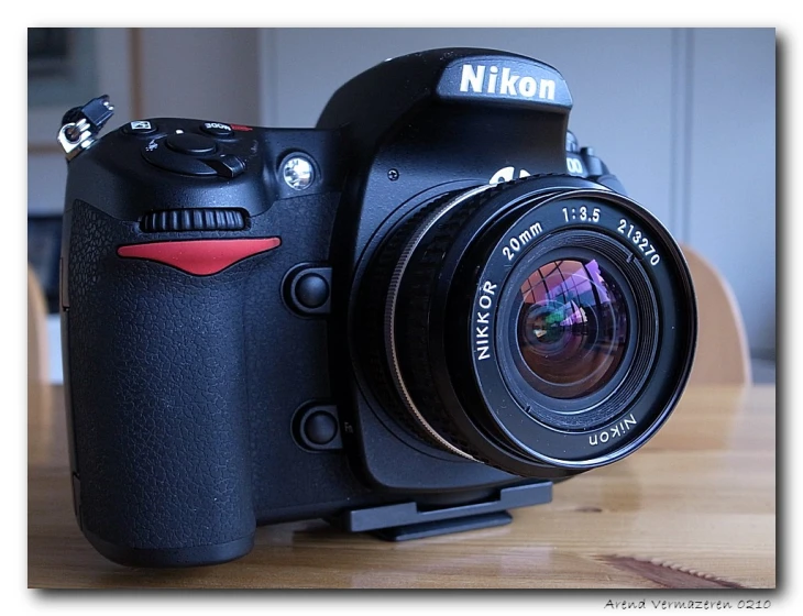 the camera is sitting on a wood table