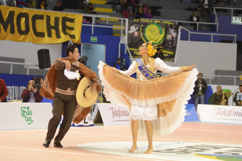 a couple of people are performing in an arena