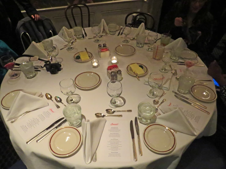 people are gathered around a table covered in food