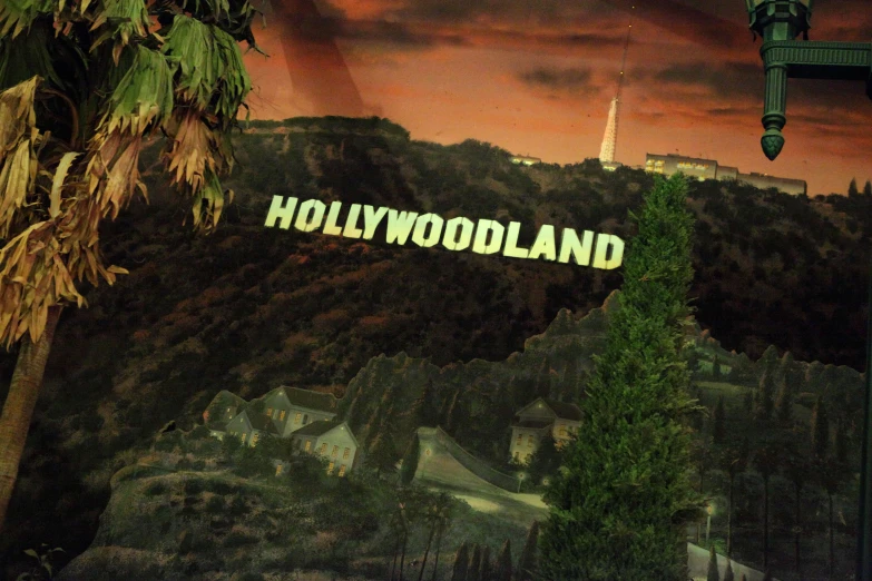 the hollywoodland sign stands on a hillside surrounded by palm trees