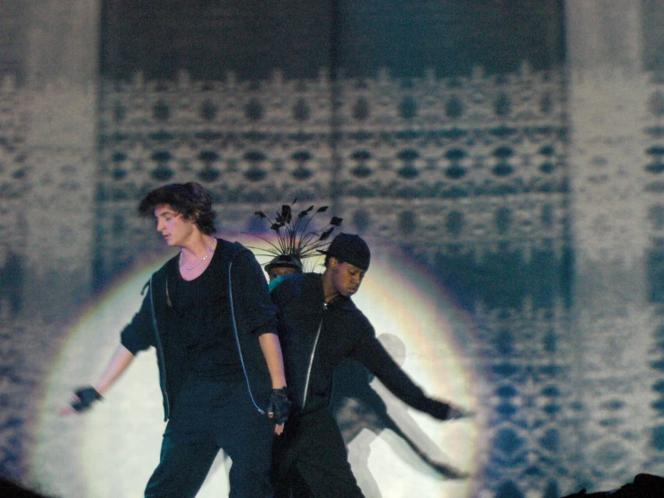 the boy and girl are performing in front of a projected image