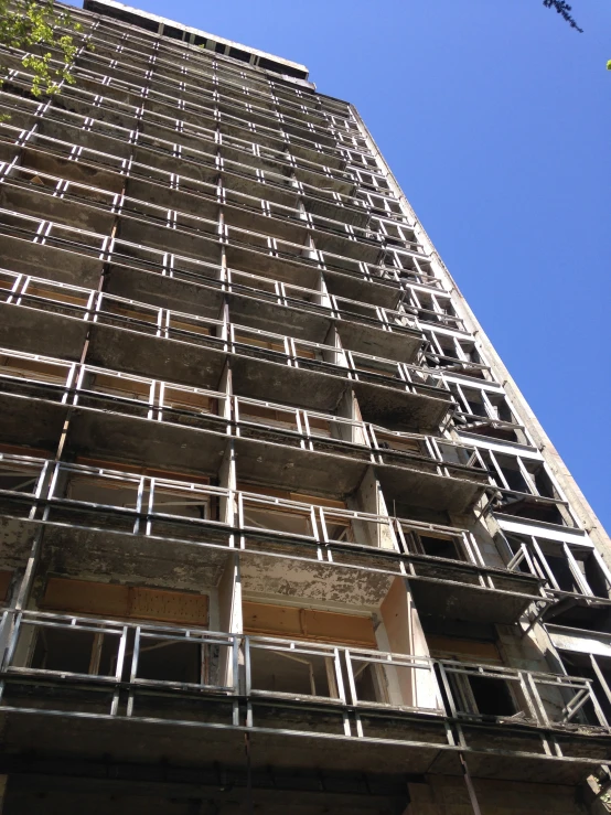 an upward view of a tall building under construction