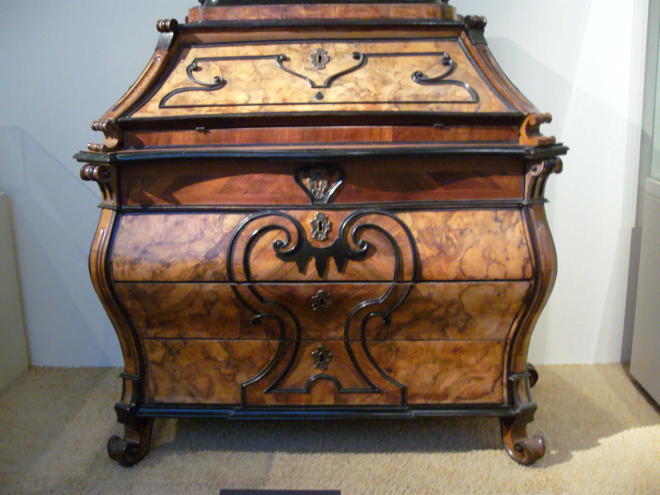 an antique wooden chest with intricate carvings on the front