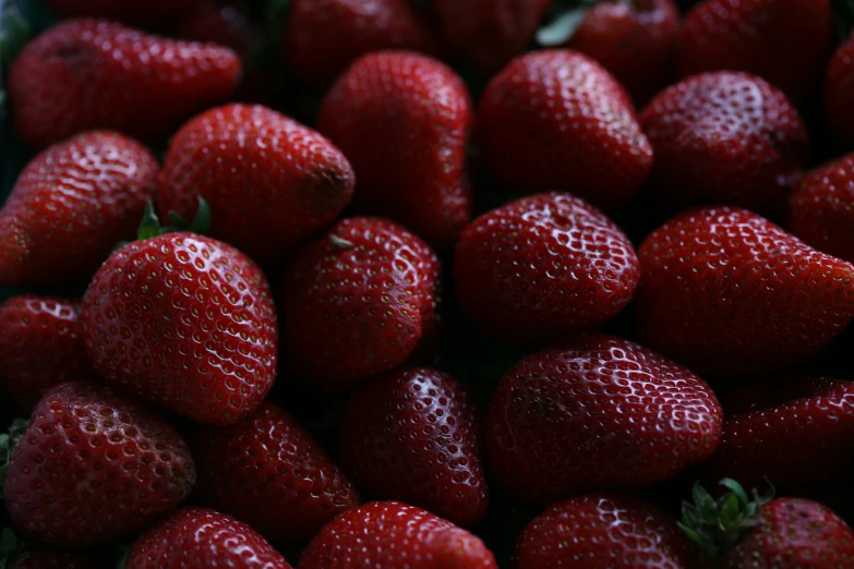 a pile of red strawberries stacked on top of each other
