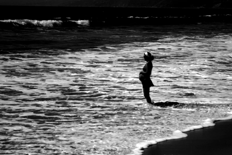 a person walks through some water at the beach