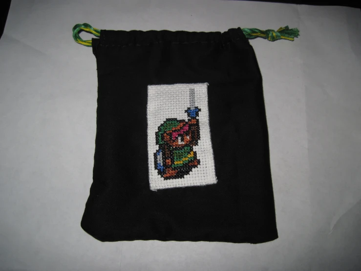 a small bag with an embroidered animal on the side of it