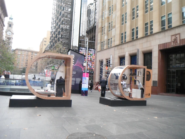 an outdoor display of various modern objects in the city