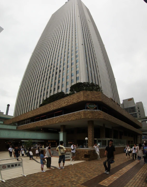 people in front of an observation center that is a modern skyscr