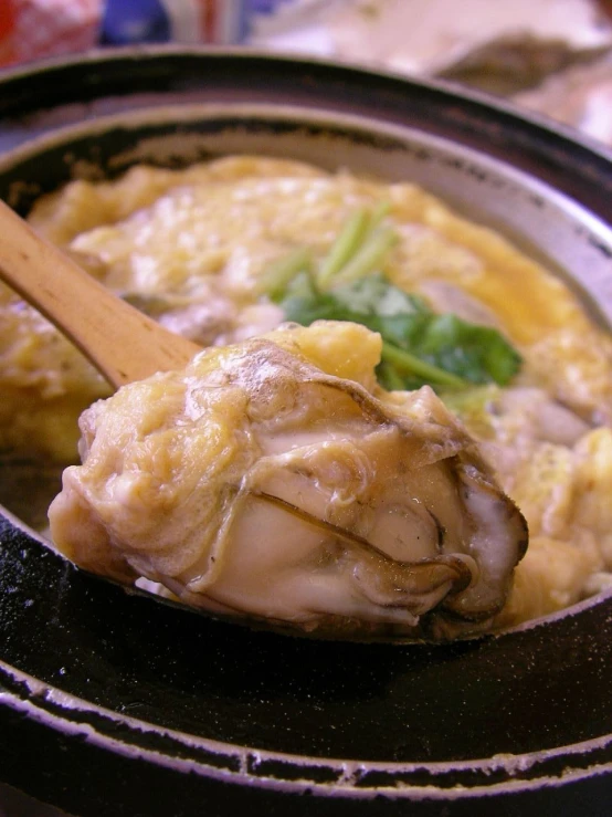 a spoon is in the middle of a casserole