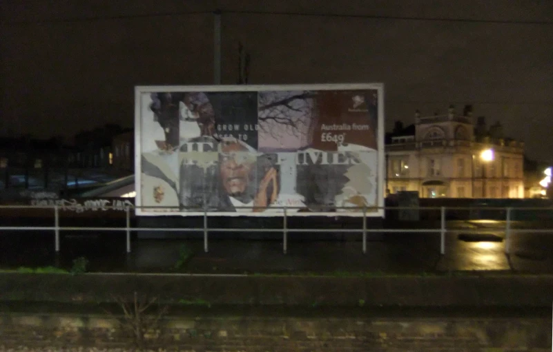 a billboard on the side of the road at night