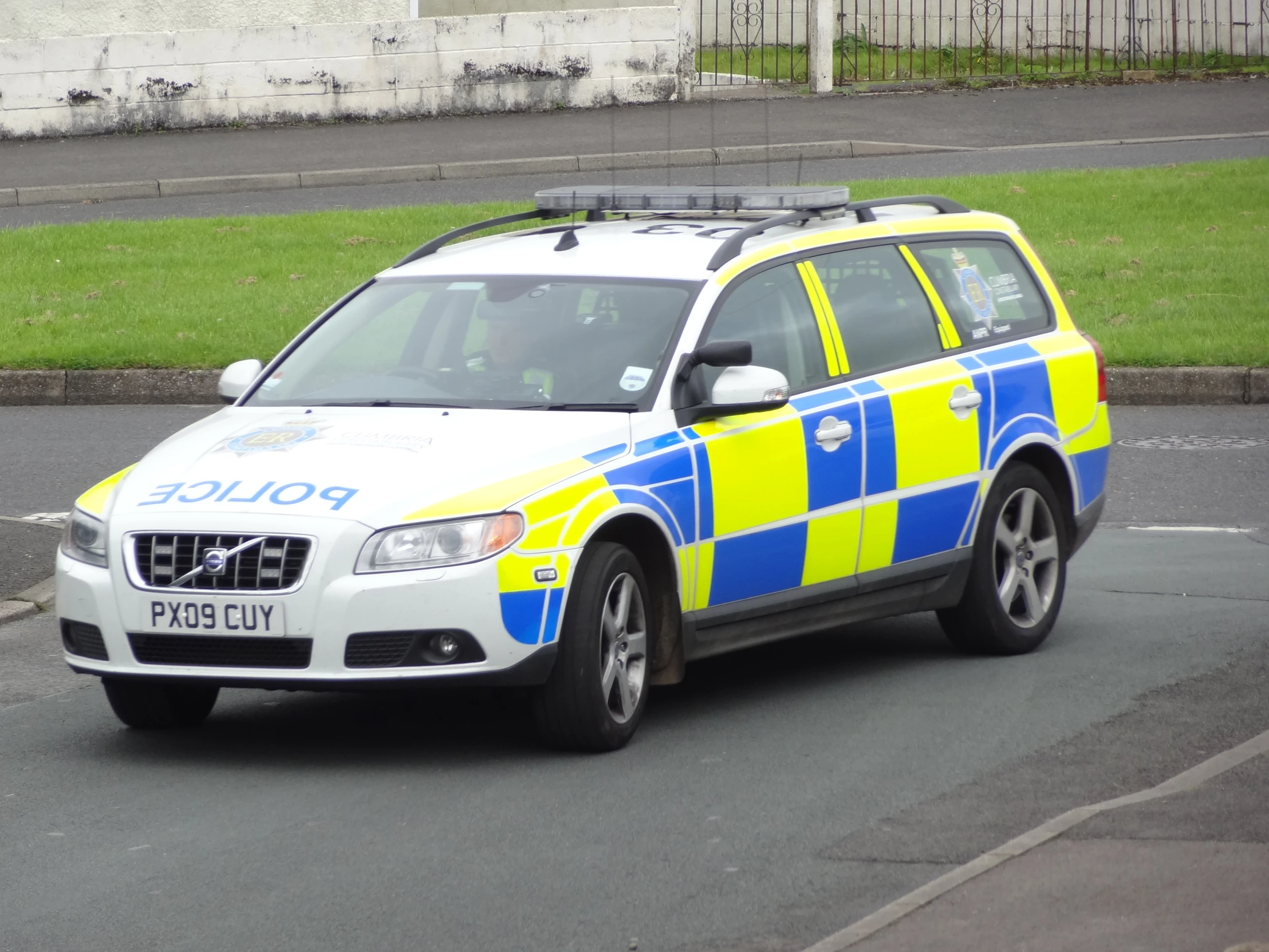 an suv with yellow, blue and white stripes on the front