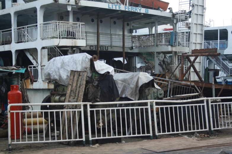 a ferry on the beach covered with tarps and fencing