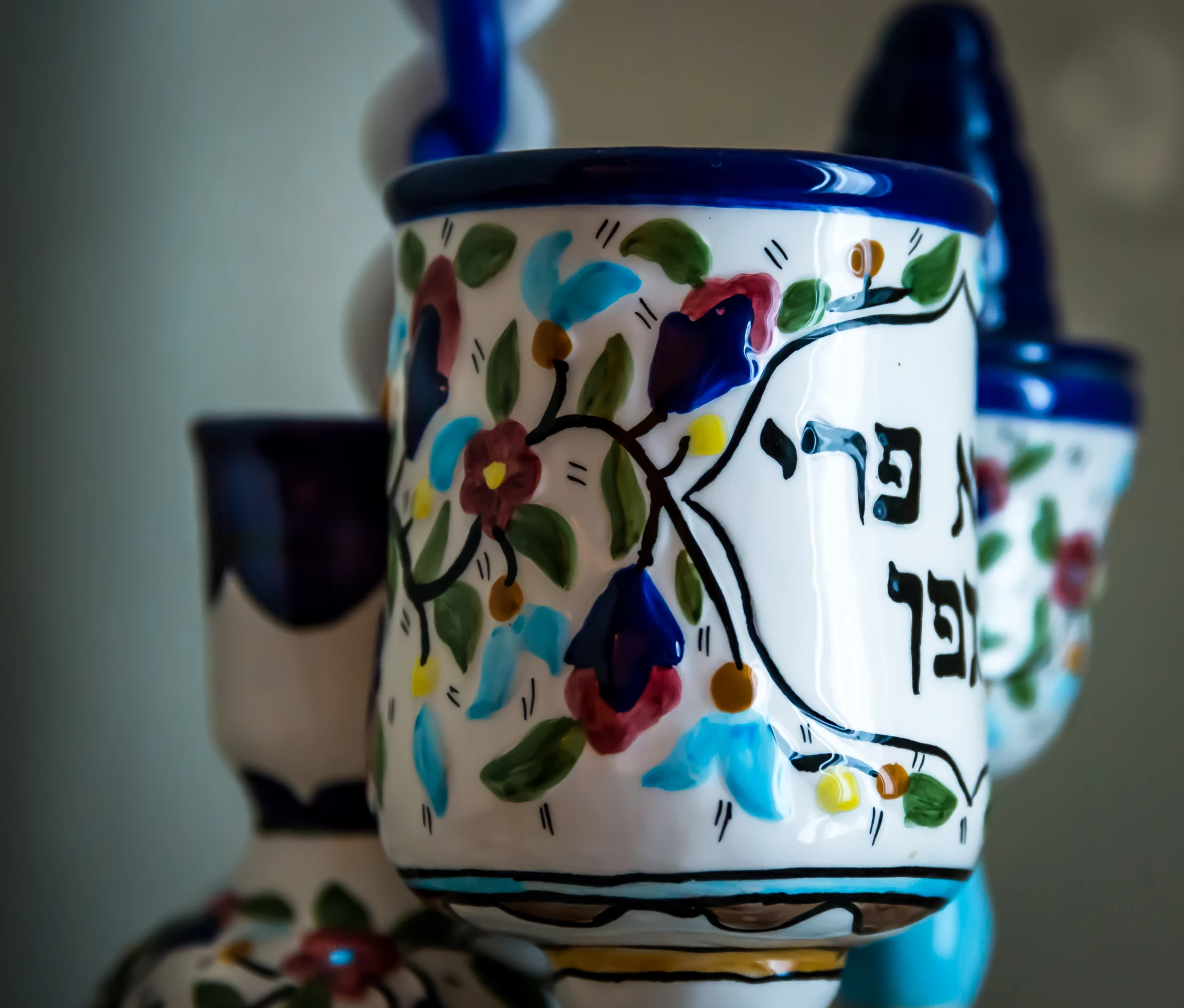 several ceramic cups with an artistic design on them