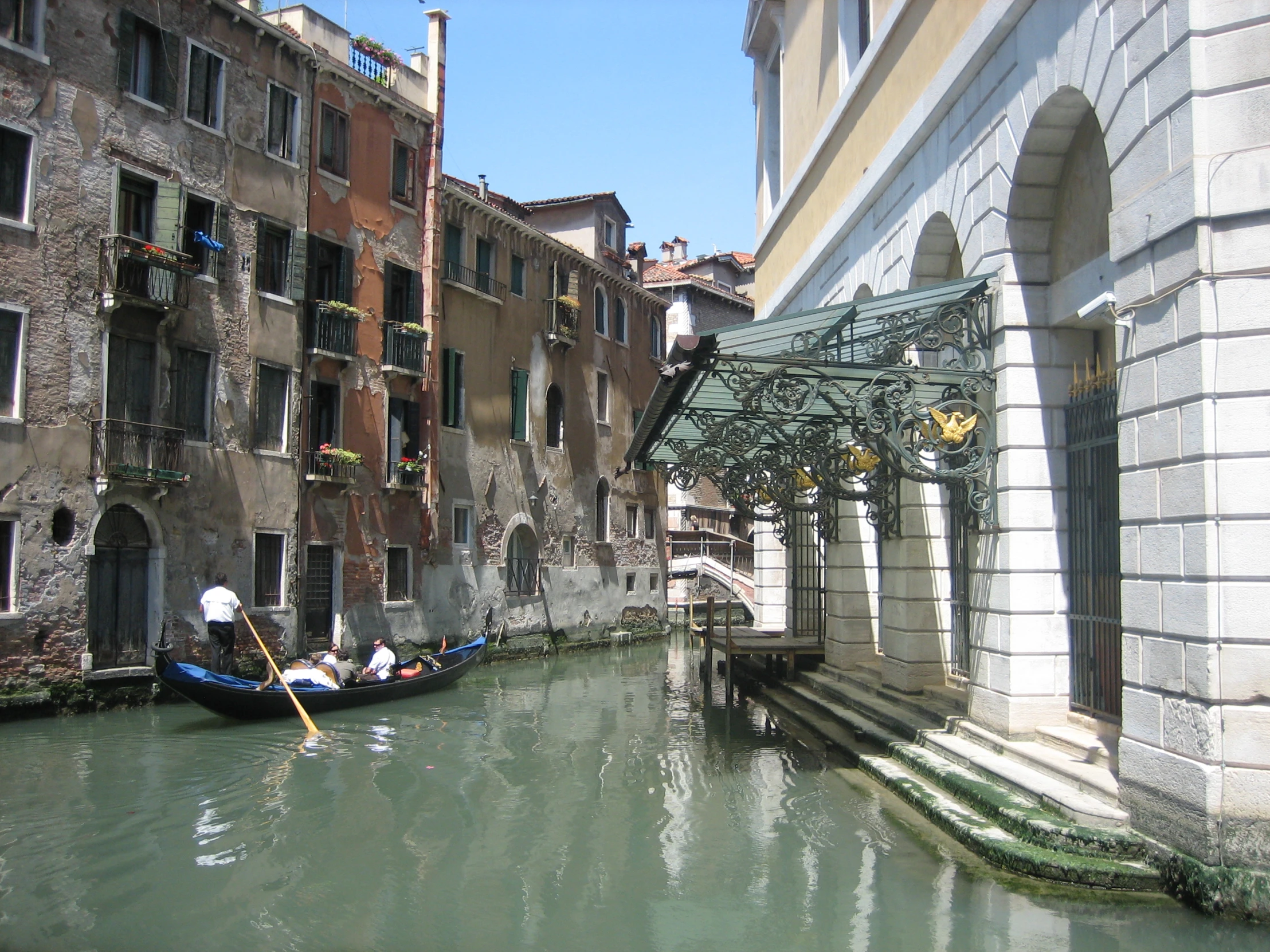 a group of people riding in boats down a canal