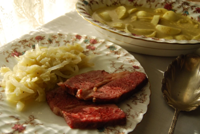 an assortment of food on a plate with silver spoon