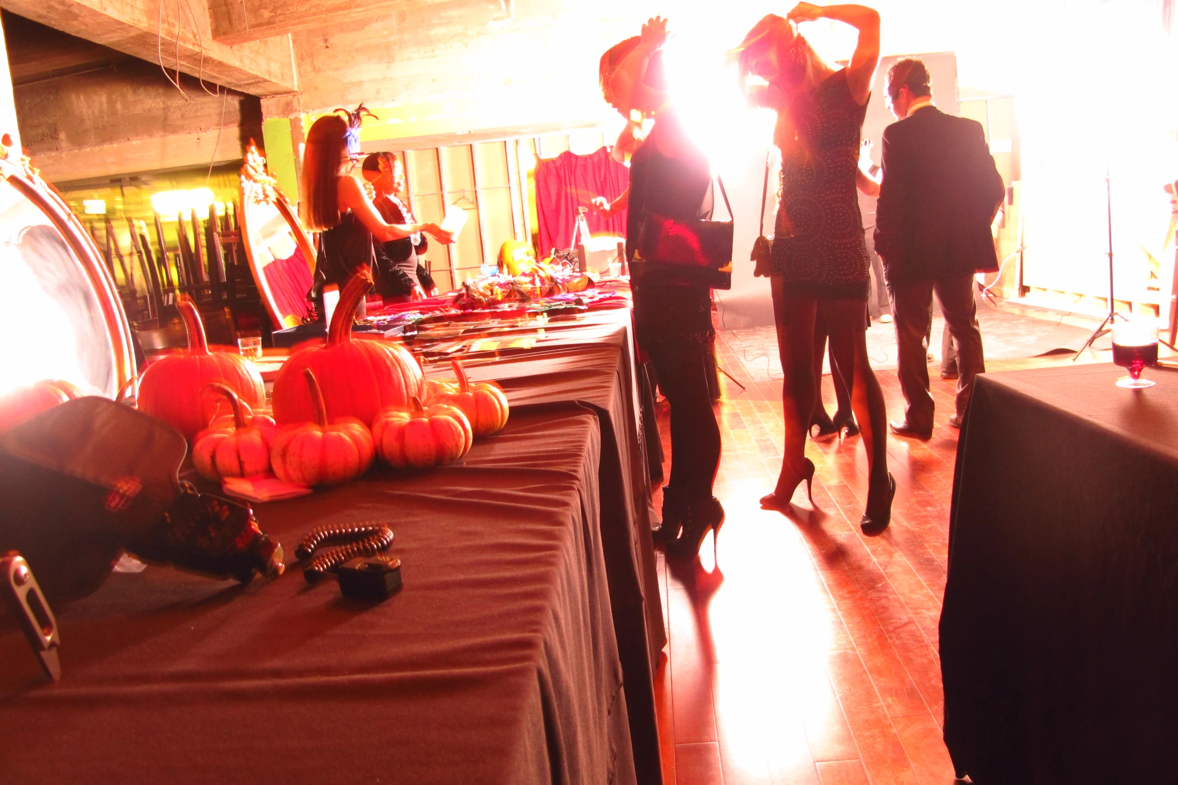 a group of people standing around a table filled with halloween treats