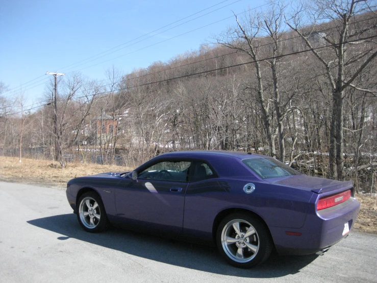 a purple car is parked on the side of the street