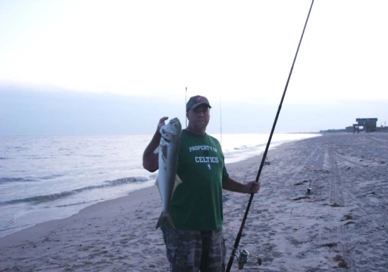 a person with a fish on a beach