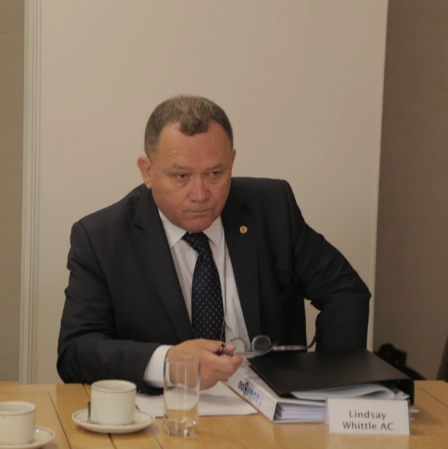 a man is reading an ordinary book at his office