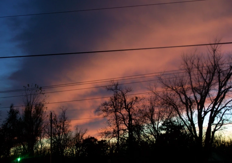 the sky is purple as a cloud sets