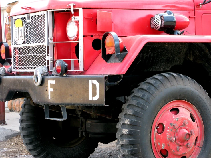 red fire engine with a few lights and a hose