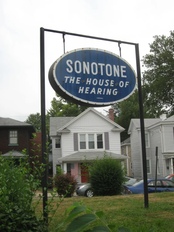 a blue and white sign for sonottone the house of hearing