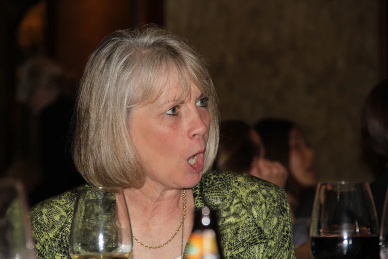 a blonde woman talking on the phone in a restaurant