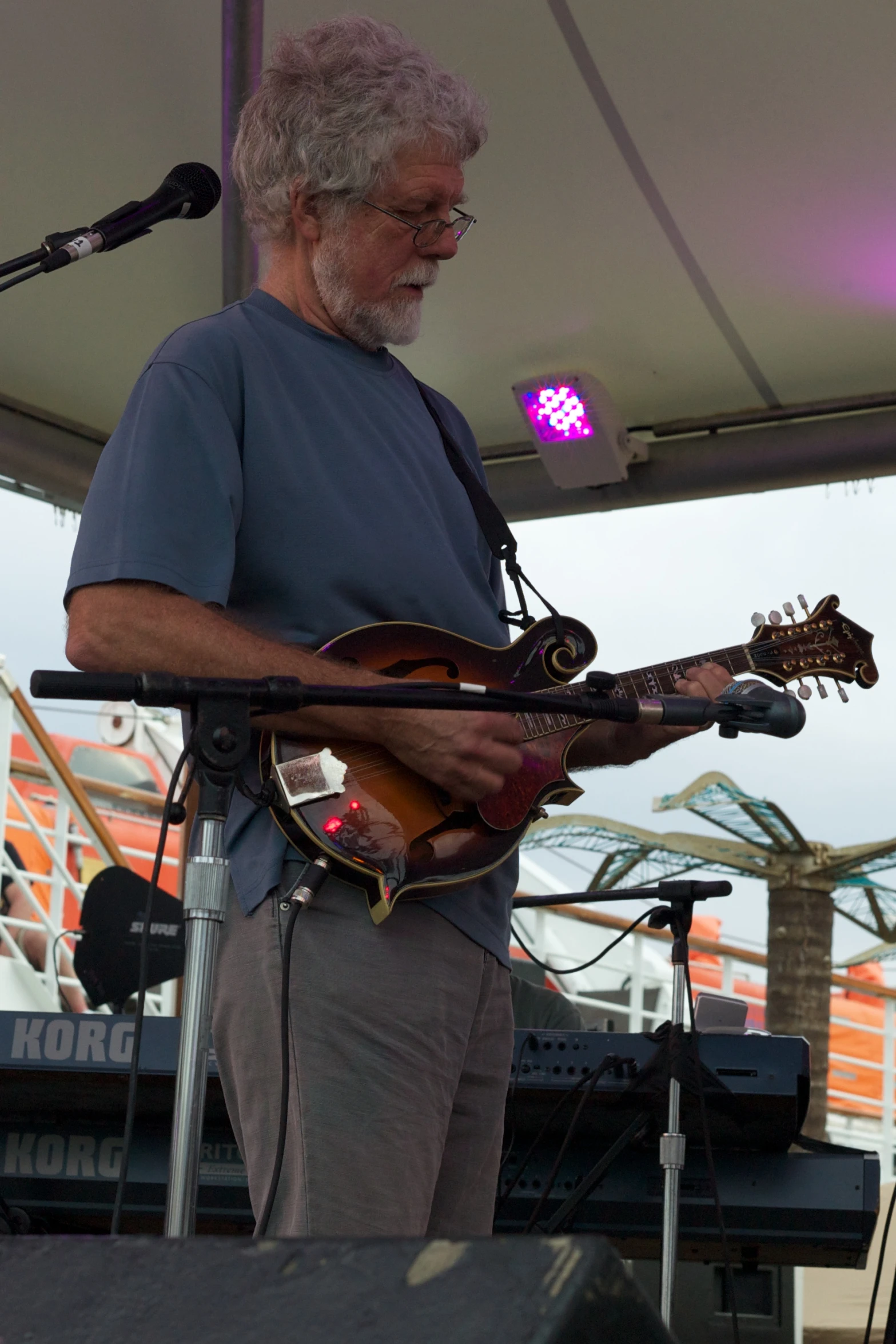 the man is playing the guitar under the awning