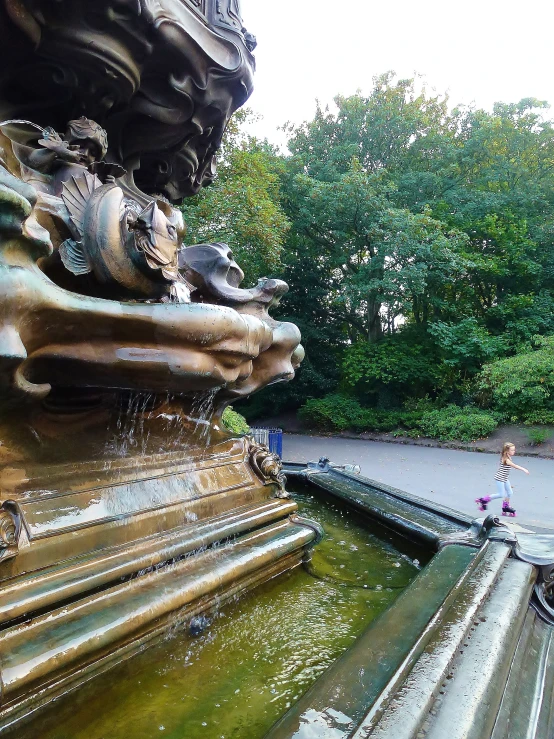 a water fountain with a large metal structure