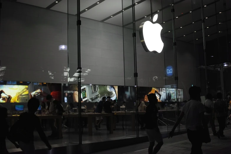 apple store with lots of people on the wall