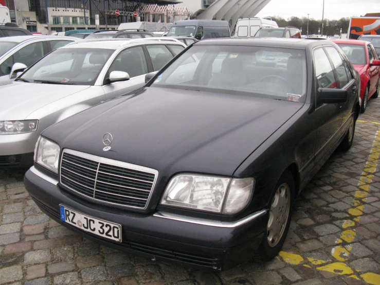 many cars parked next to each other on a street