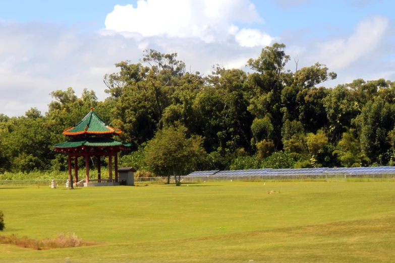 a gazebo with a canopy in a field