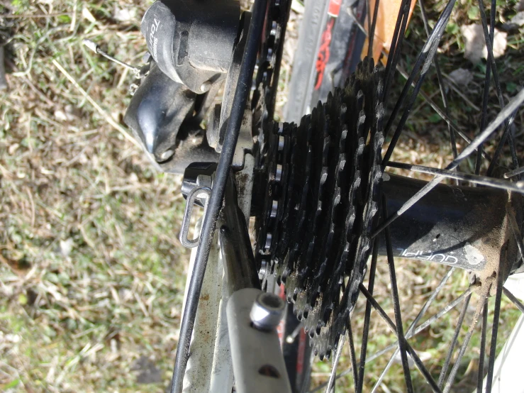 a bicycle is locked with gears sitting on a bicycle rack