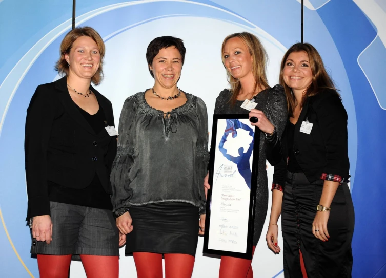 two women holding up a plaque that reads'women in business '