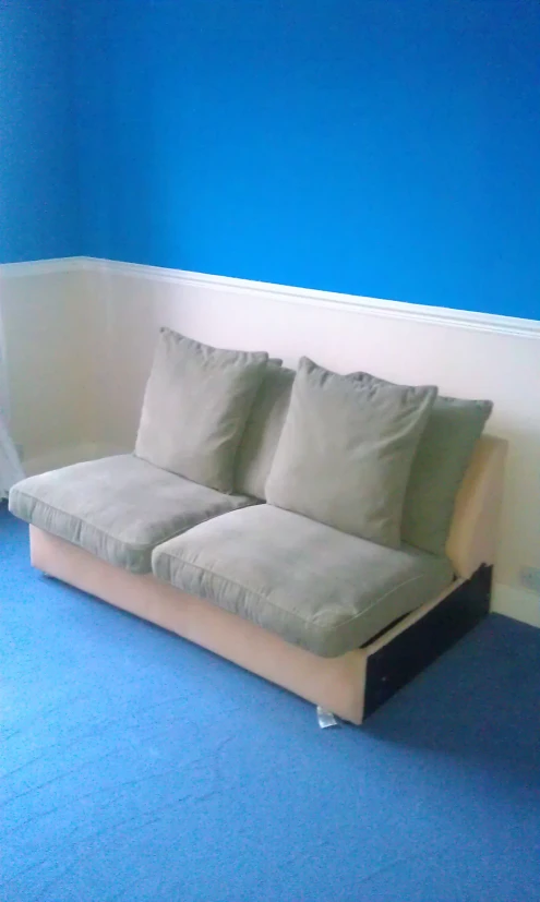 a modern style sofa has several pillows on the back