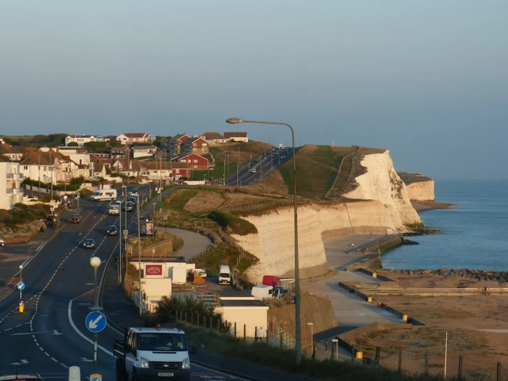 a street next to the beach with houses on it