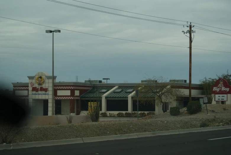 an old commercial store sitting on the side of the road