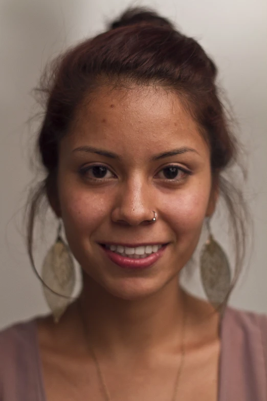 a close up of a person wearing earrings