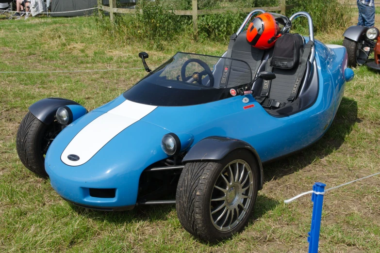 a light blue and white car with two seats on display