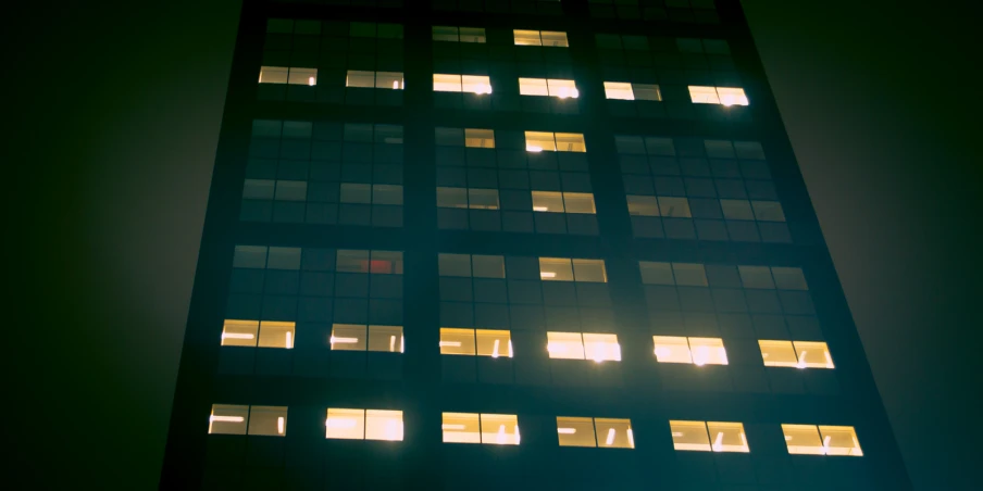 a very tall building with some windows lit up