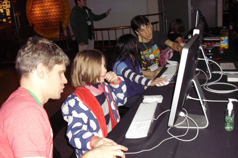 people working on computer at night and looking at screen