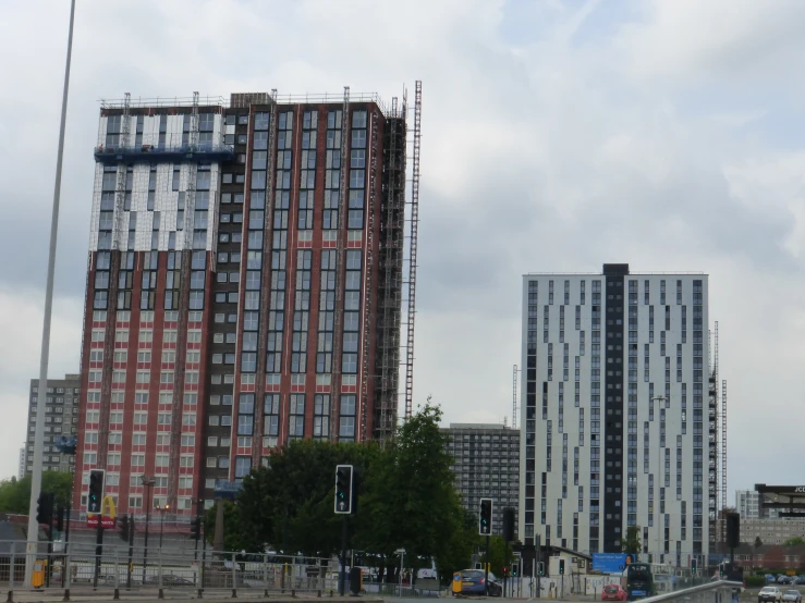 a tall building sitting next to some other tall buildings