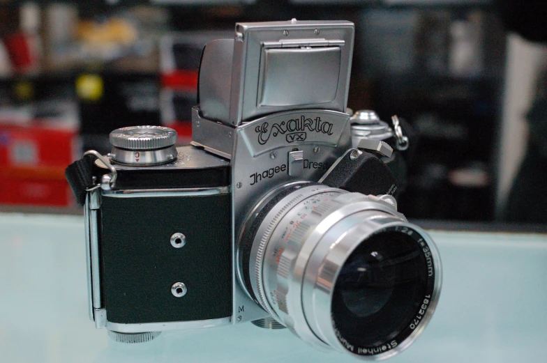 a silver colored camera on display on a table