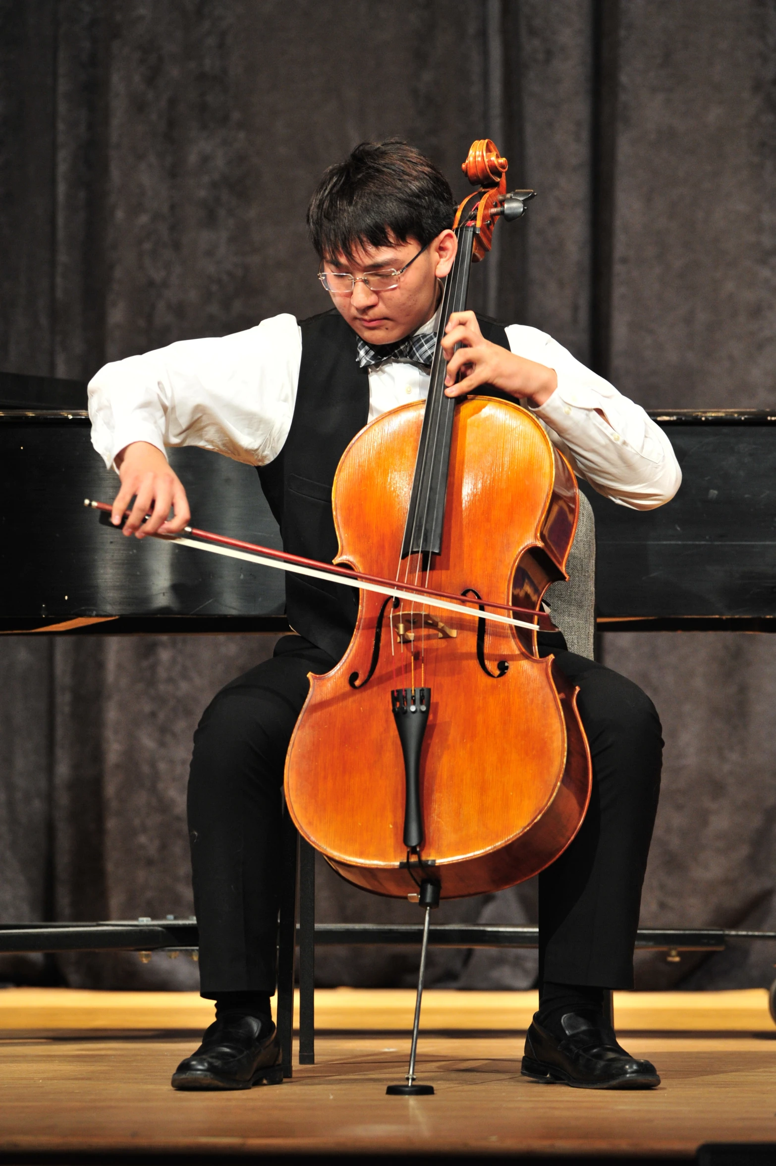 a man is playing an instrument on stage