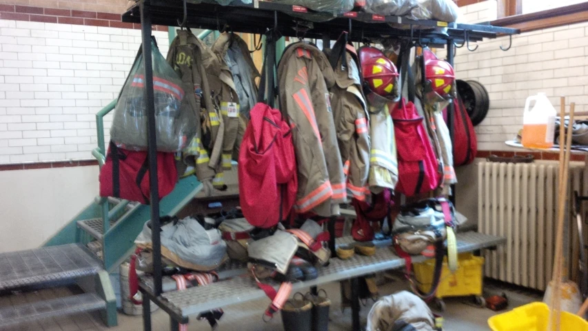 a bunch of fireman's hats on a rack